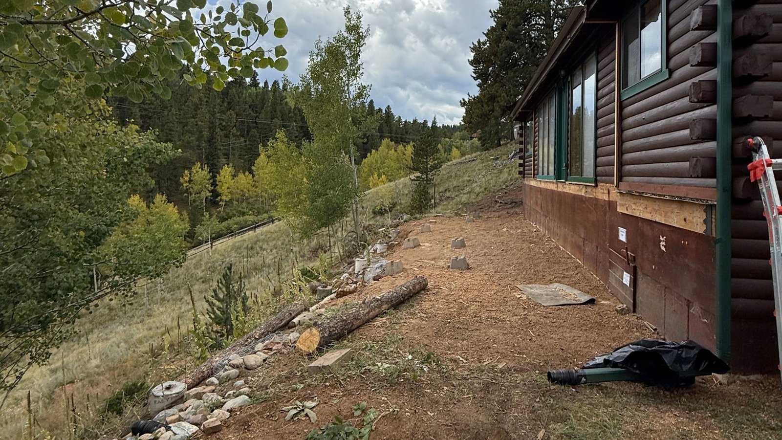 Regraded slope and drainage work alongside a foothills home